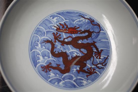 A Chinese iron red and underglaze blue dragon dish, Qianlong seal mark and of the period (1736-95), diameter 17.5cm, slight faults